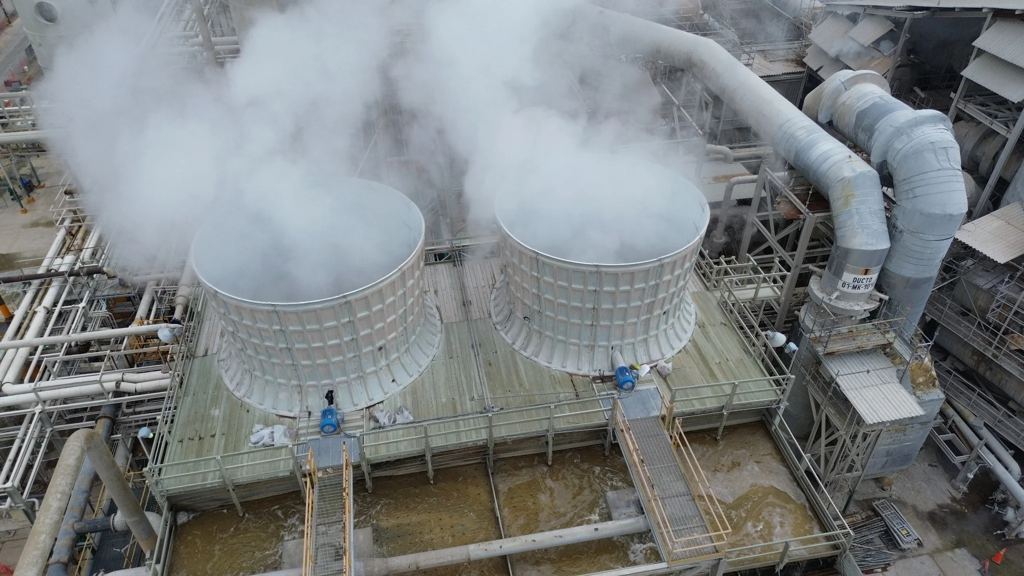 Vista aérea de torres de enfriamiento y ductos en una instalación industrial